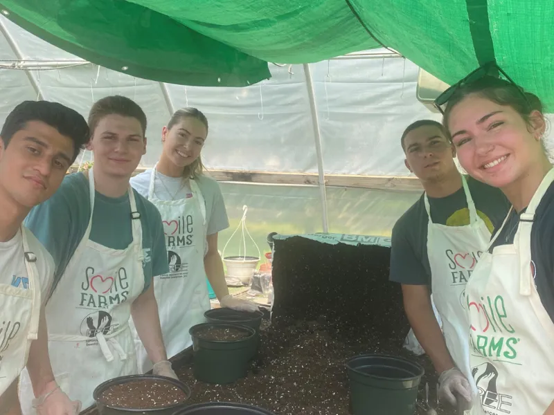 group of smiling people volunteering